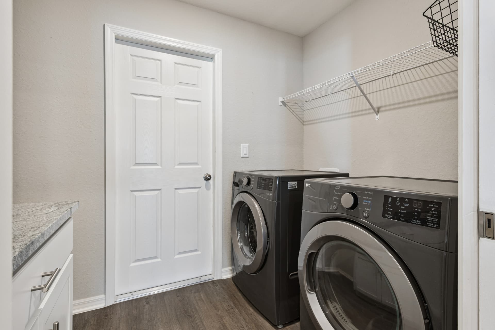 Laundry room with washer, dryer, and shelving