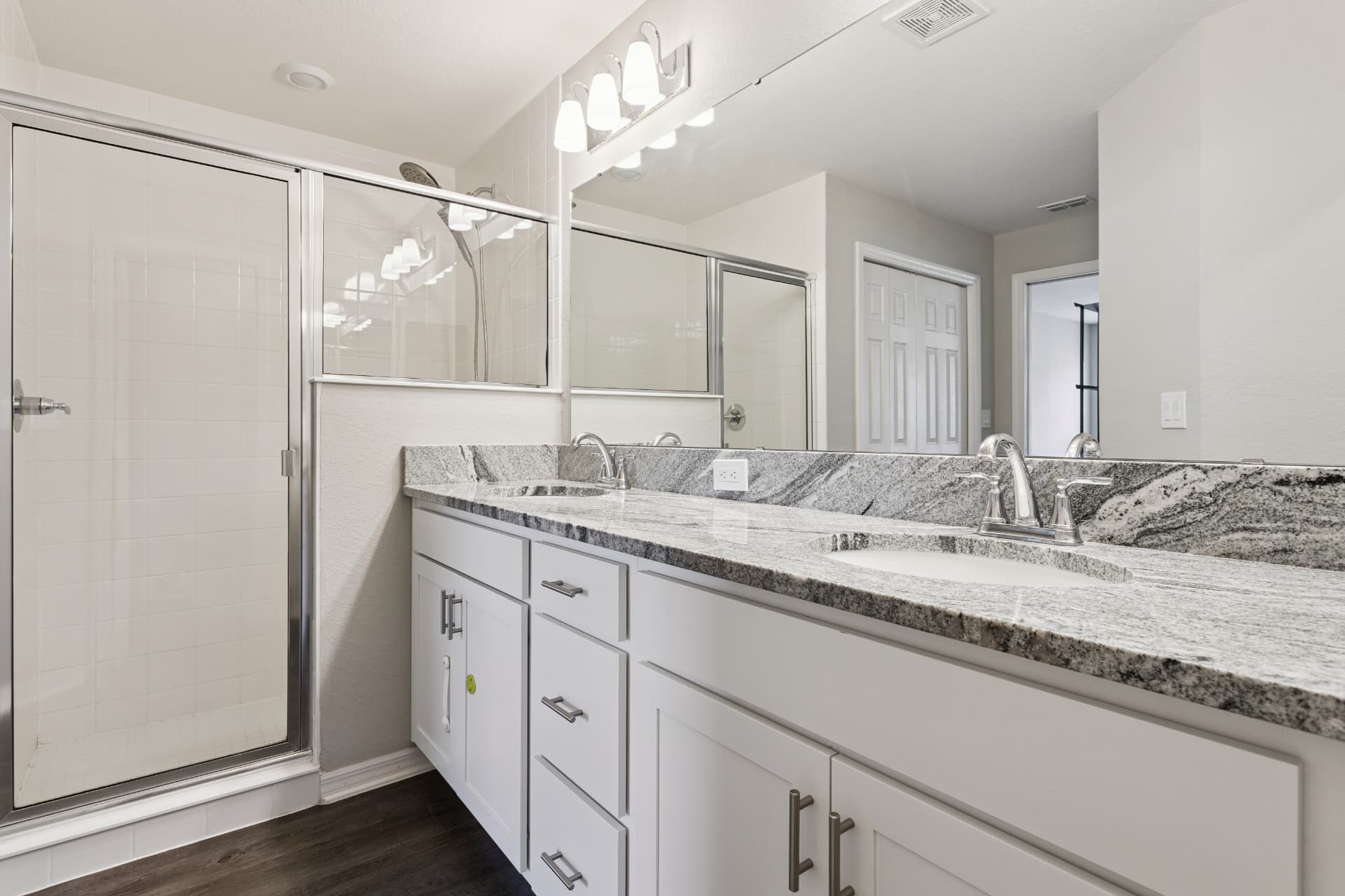 Bathroom with double vanity and shower