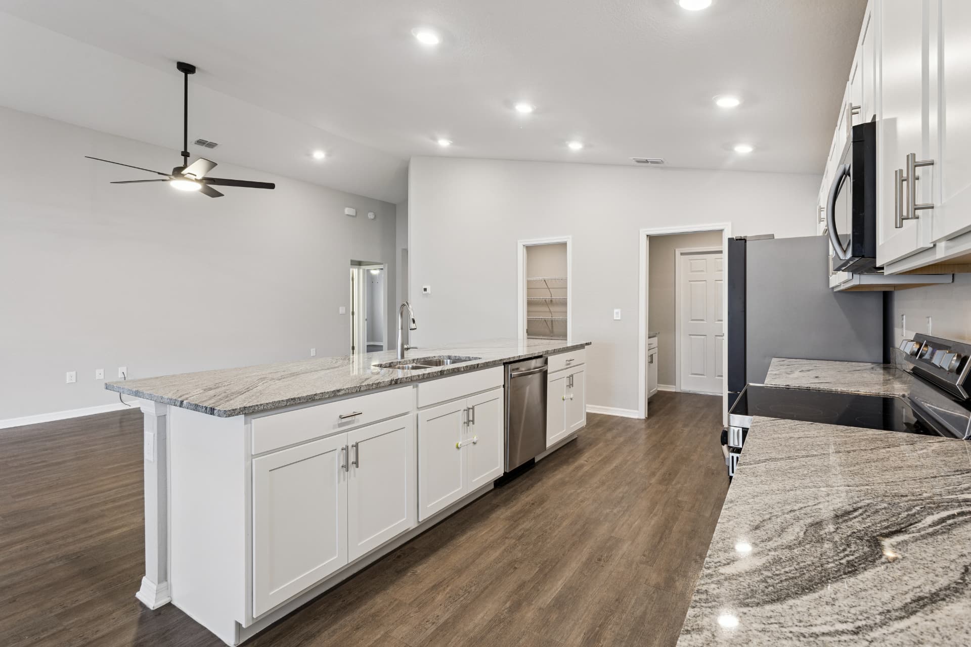 Kitchen with island, pantry, and stainless appliances