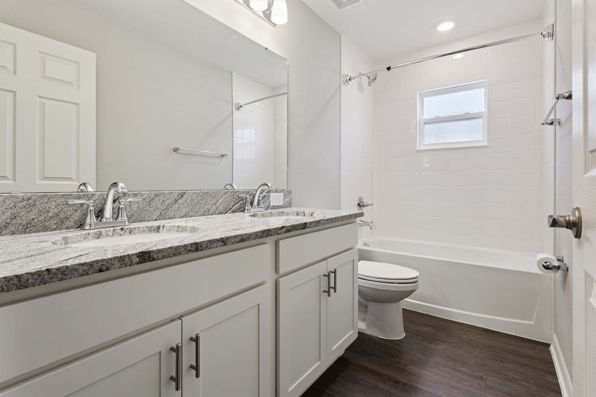 Bathroom with double vanity and tub