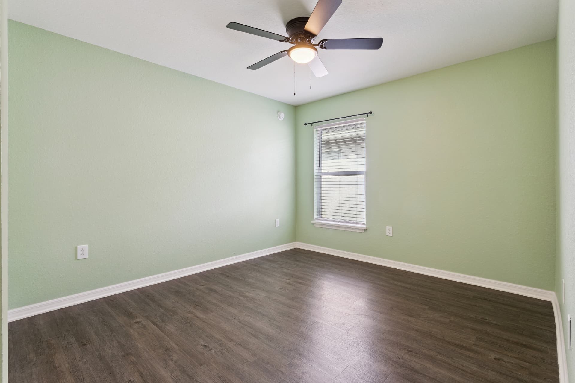 Bedroom with ceiling fan and window