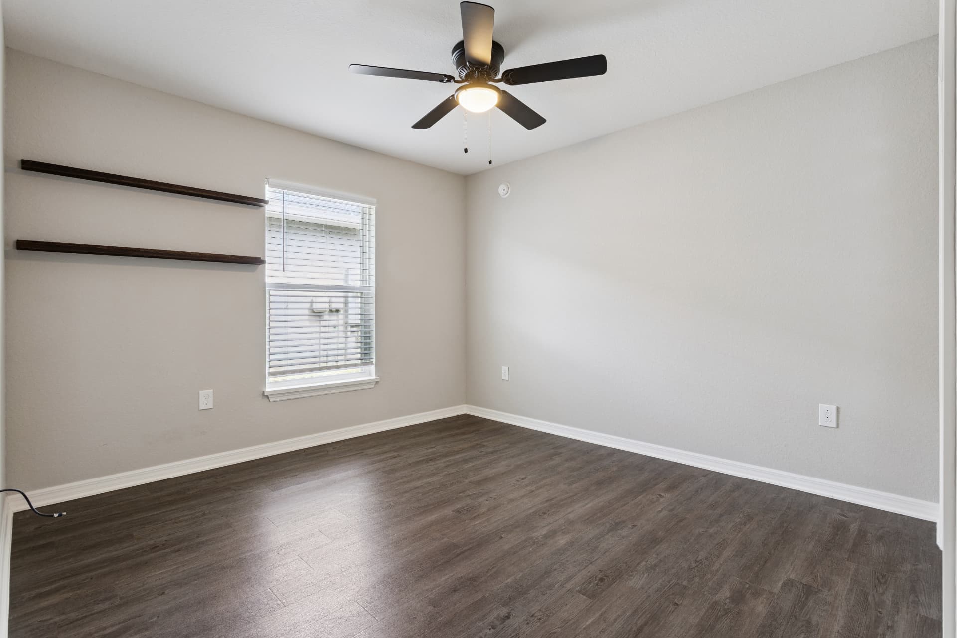 Bedroom with ceiling fan and built-in shelves